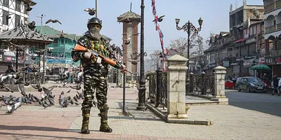A security person stands guard near Lal Chowk during a strike called by Jammu and Kashmir Liberation Front (JKLF) to mark the 37th death anniversary of JKLF founder Mohammad Maqbool Bhat, who was hanged in New Delhi's Tihar Jail on this day in 1984, in Srinagar, Thursday, Feb. 11, 2021. Photo: PTI/S. Irfan
