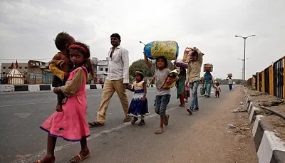 Migrant workers walk with their children to their villages after India announced a nationwide lockdown due to the coronavirus pandemic. Credit: Reuters