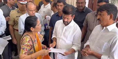 Telangana chief minister A. Revanth Reddy interacts with a woman during a grievance redressal programme on Friday, December 8, 2023, in Hyderabad. Photo: Twitter/@revanth_anumula 